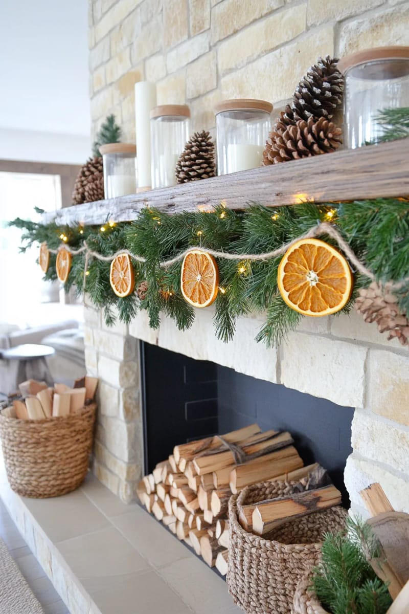 pinecone garland strung across the mantle with twine and dried orange slices 1