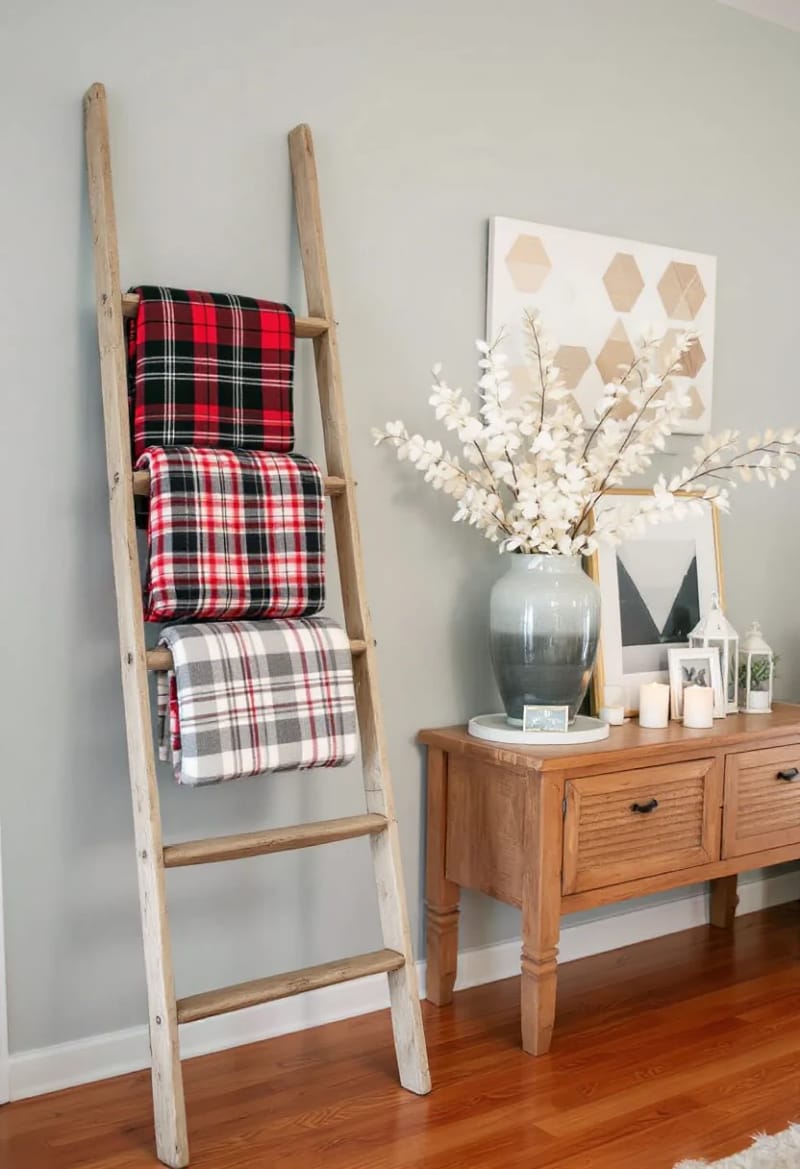 19 Creative Upcycled Home Decor Ideas to Refresh Your Space 15 rustic ladder transformed into a cozy blanket rack 1
