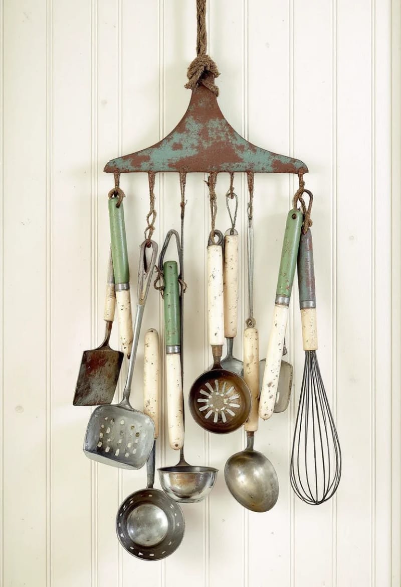 19 Creative Upcycled Home Decor Ideas to Refresh Your Space 51 upcycled garden rake head used as a rustic kitchen utensil holder 1