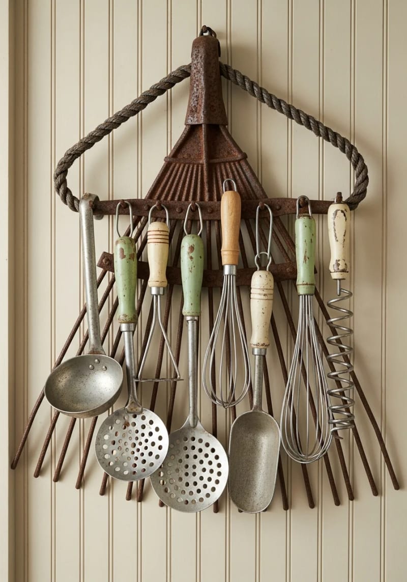 19 Creative Upcycled Home Decor Ideas to Refresh Your Space 52 upcycled garden rake head used as a rustic kitchen utensil holder 1