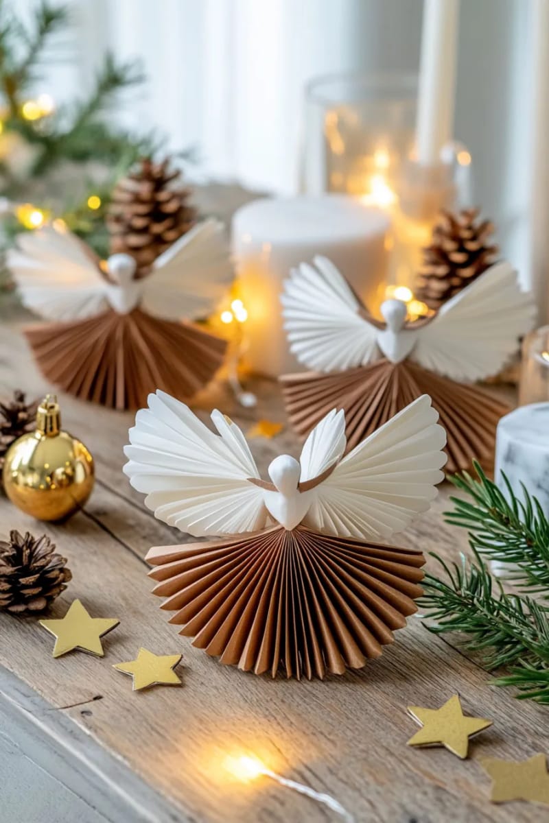accordion-folded angel figurines in metallic and white paper 1