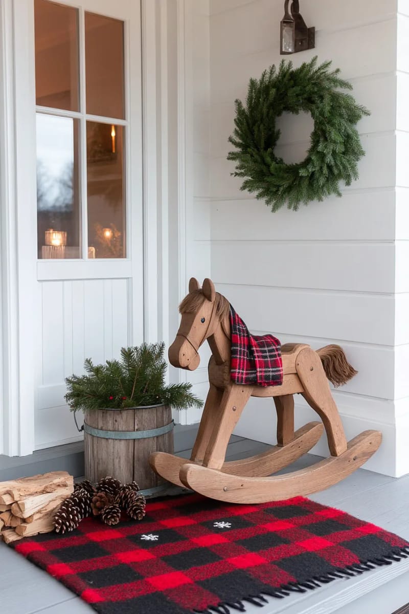 15 Cozy Rustic Christmas Porch Ideas for Country Charm 27 antique rocking horse surrounded by greenery, pinecones, and a buffalo plaid throw 1