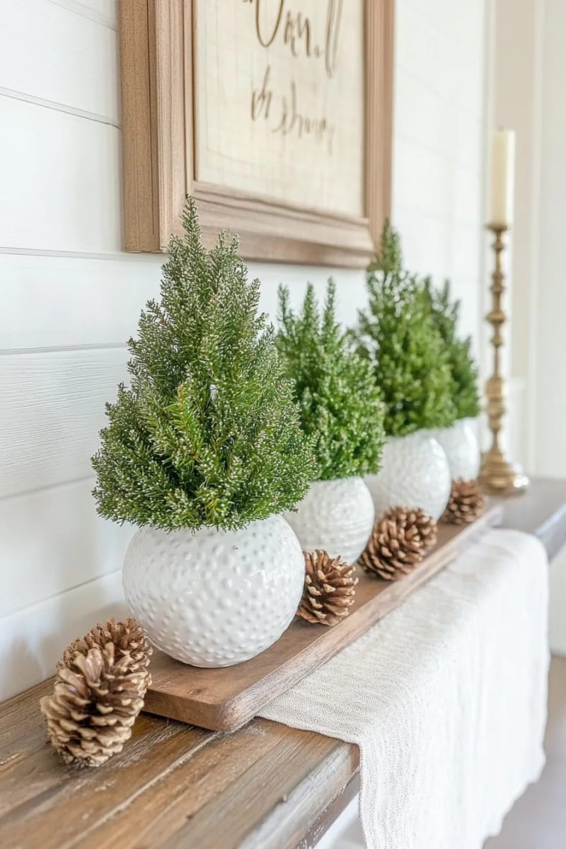 25 Green Christmas Fireplace Decor Ideas for a Fresh and Festive Mantel 40 artful display of mini evergreen topiaries in white ceramic pots 1