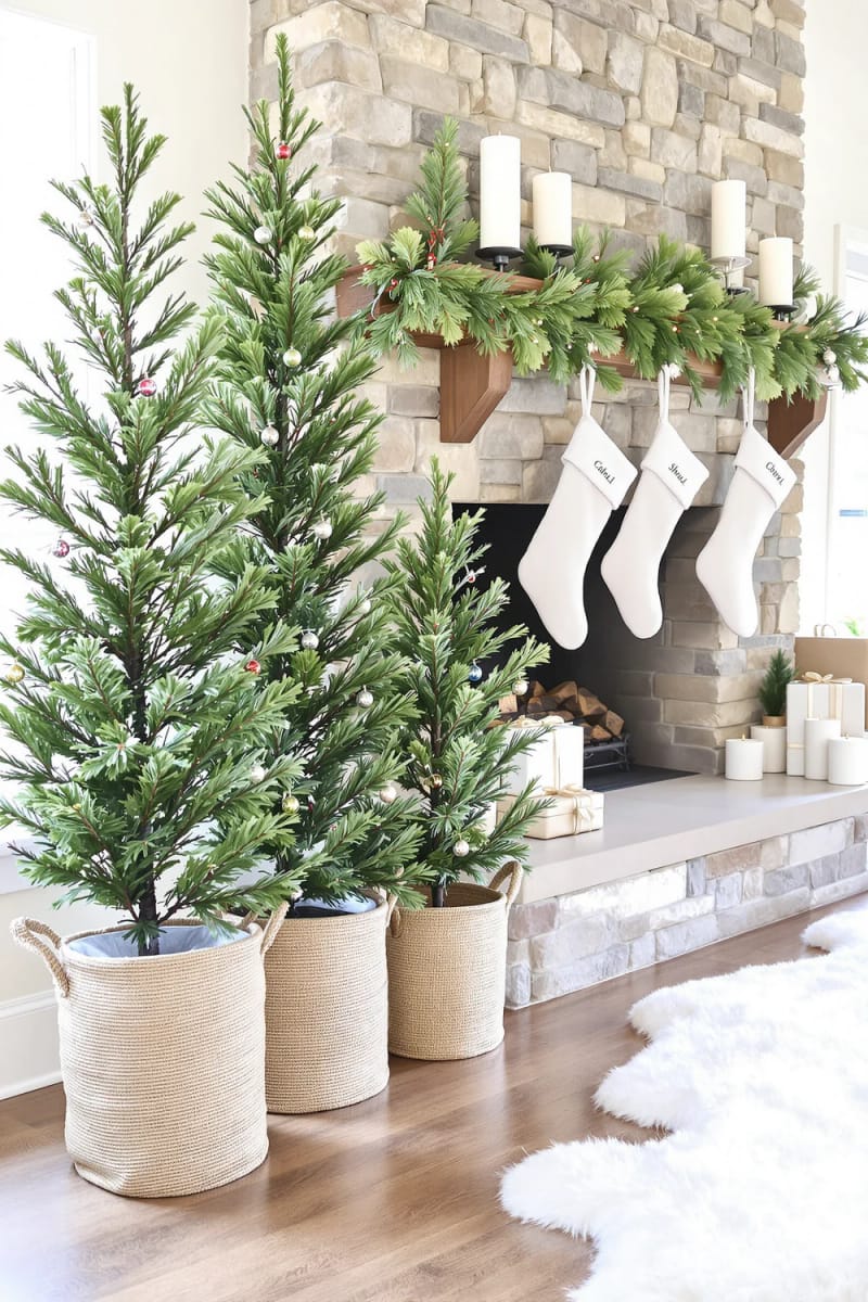 christmas tree trio flanking the fireplace, each decorated in a unique theme 1