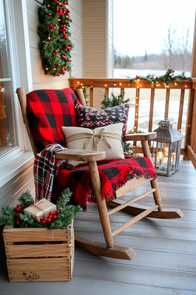 15 Cozy Rustic Christmas Porch Ideas for Country Charm 7 classic rocking chair draped with plaid flannel blanket and woolen throw pillows 1