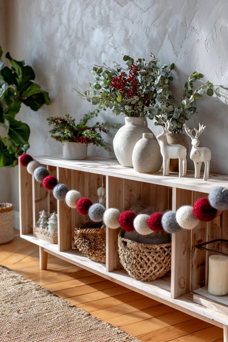 felted wool ball garlands in soft greys, creams, and reds 1