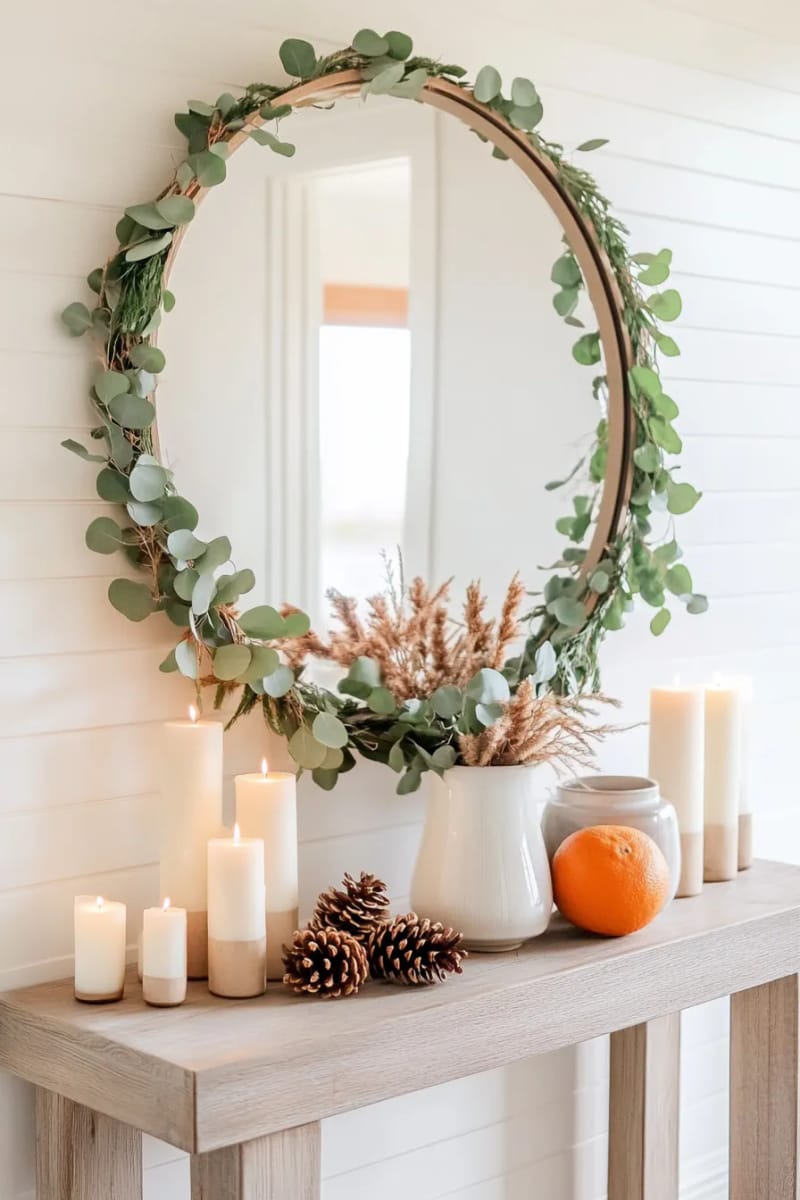 25 Tasteful Christmas Decor Ideas for a Cozy Holiday Home 47 fresh greenery and dried orange slice garland around a mirror 1