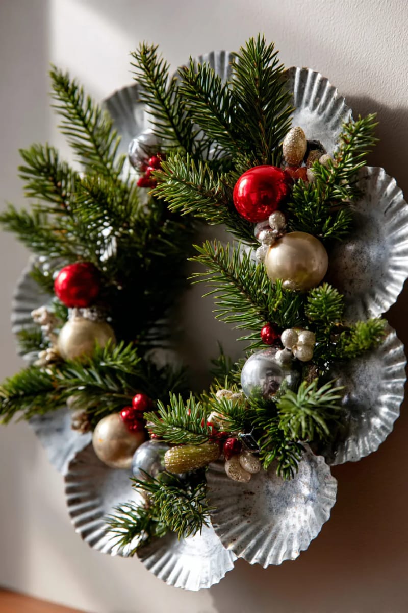 29 Upcycled Christmas Crafts For Unique Holiday DIY Projects 74 old tart tin wreath adorned with pine branches and tiny ornaments 1