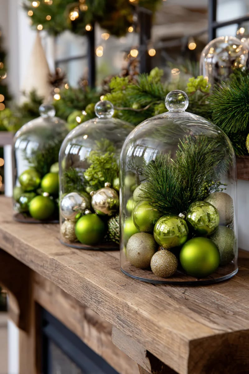 25 Green Christmas Fireplace Decor Ideas for a Fresh and Festive Mantel 57 oversized glass cloches filled with green baubles and pine sprigs 1