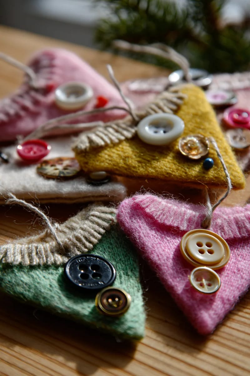 29 Upcycled Christmas Crafts For Unique Holiday DIY Projects 54 upcycled felt jumper tree ornaments with playful vintage buttons 1