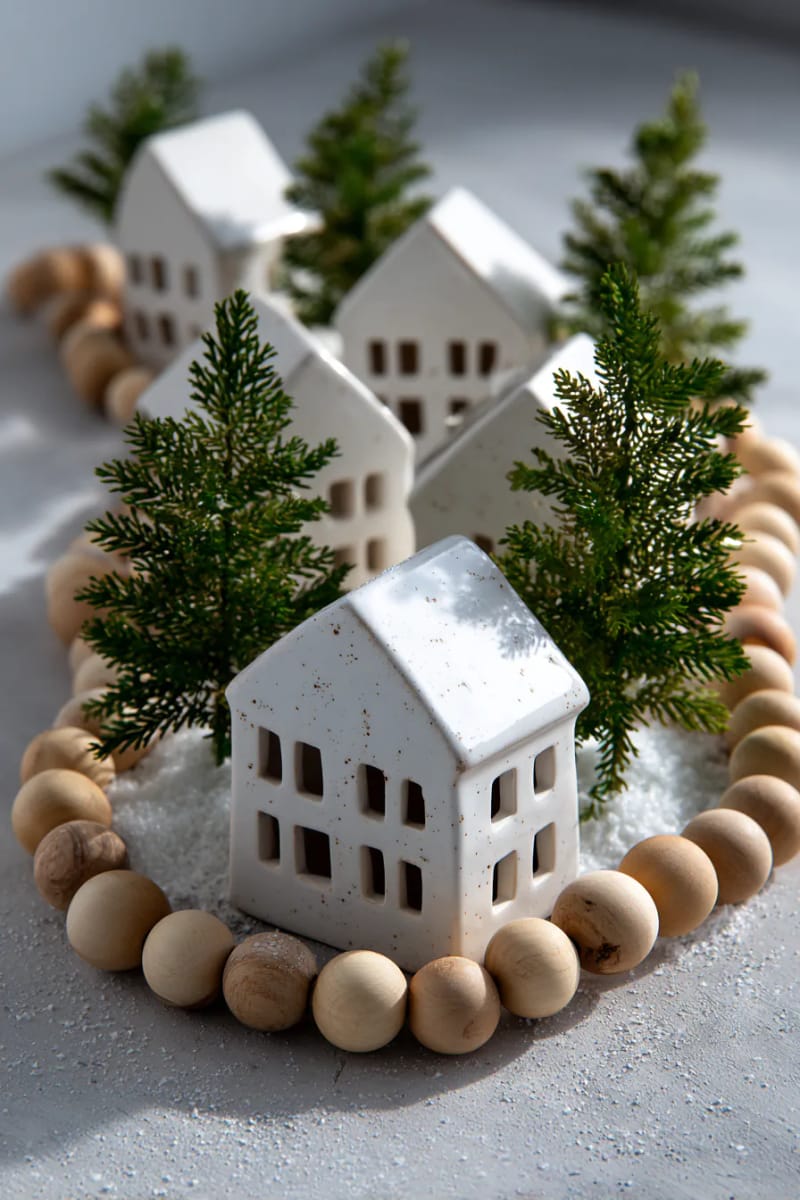 white ceramic houses with mini pine trees and wooden bead garlands 1