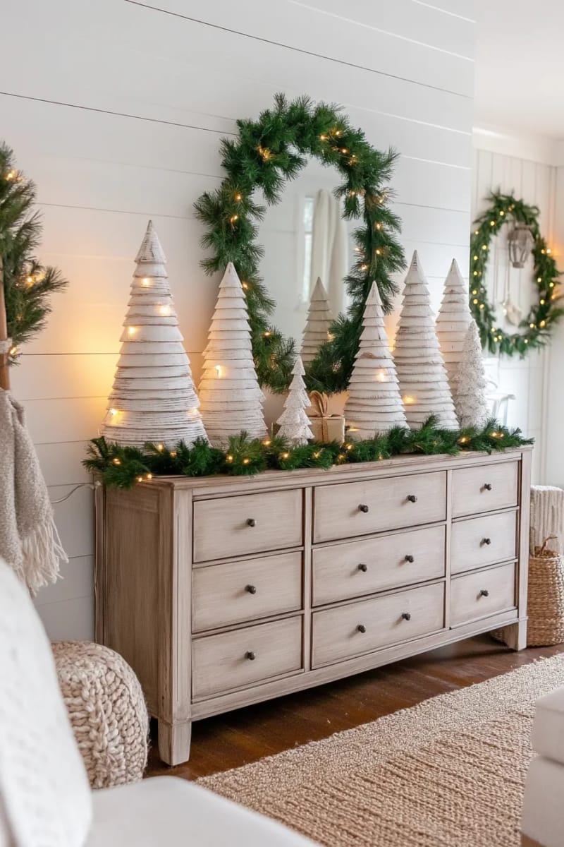 whitewashed wooden christmas trees grouped on a sideboard 1