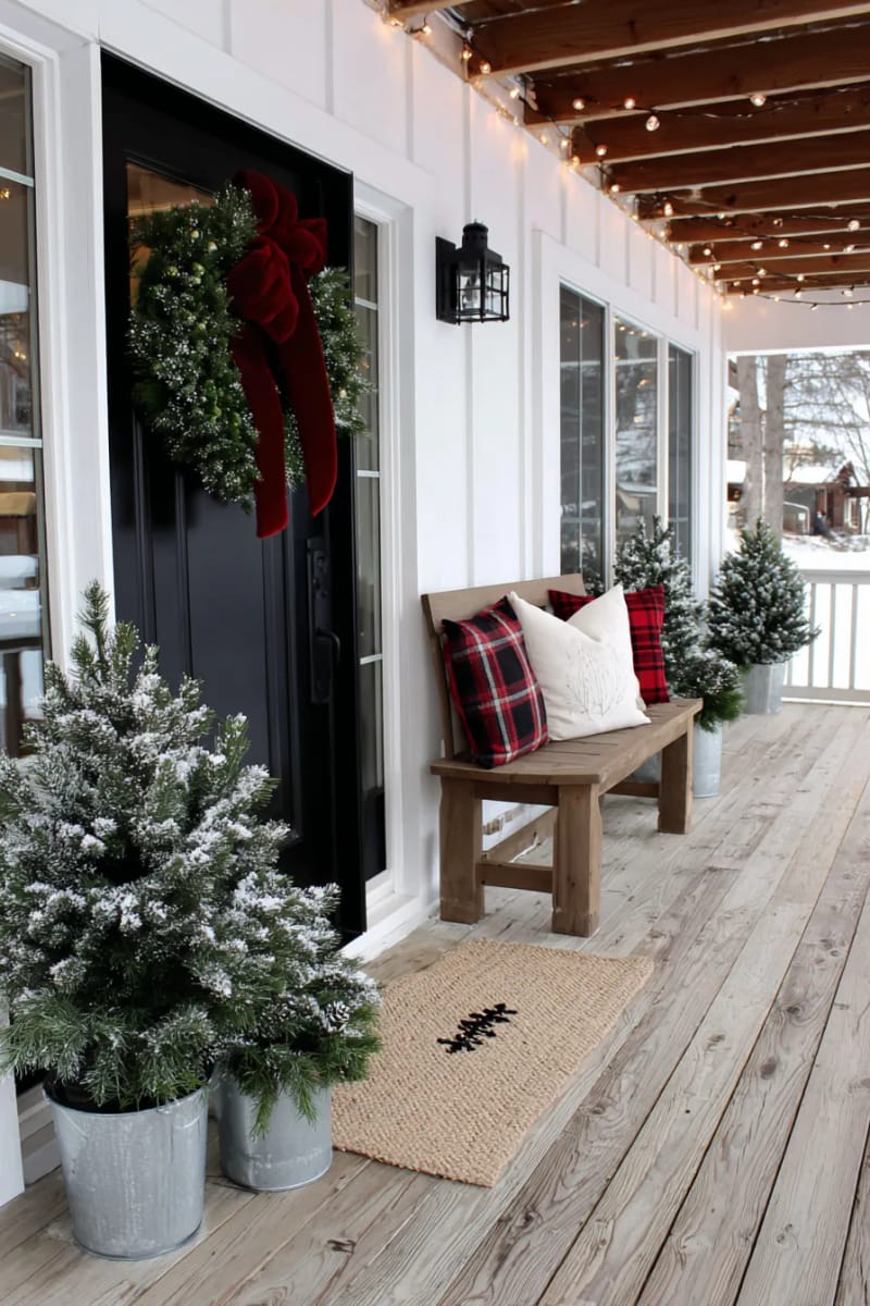 15 Cozy Modern Farmhouse Christmas Ideas For Front Porch 2025 15 classic boxwood wreath with oversized velvet bow on matte black front door 1