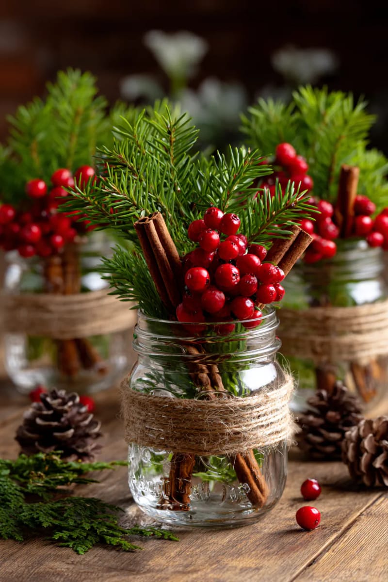 mason jars wrapped in twine, holding cedar, berries, and cinnamon sticks 1