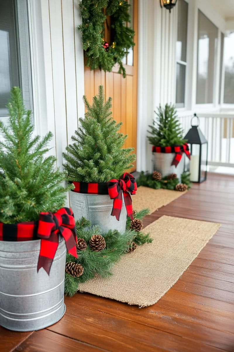 15 Simple Farmhouse Christmas Front Porch Decor Ideas 3 mini pine tree cluster in galvanized farmhouse buckets with plaid ribbon bows 1