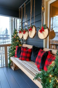minimal wood slice ornaments hung from porch beams with red plaid scraps 41