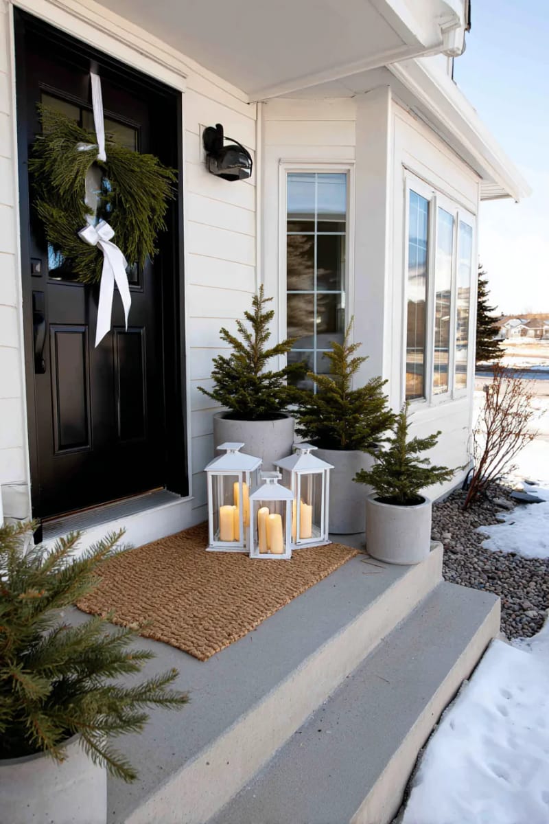 white lanterns with battery candles clustered by the front mat 1