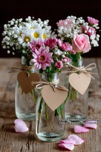 21 Nature-Inspired Valentines Day Decorations You'll Love 1 mini flower bouquets in vintage milk bottles with kraft paper hearts 41