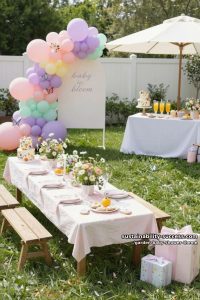 pastel outdoor picnic with balloon arches, wildflowers, and “baby in bloom” theme 25