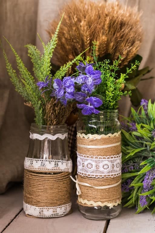 Recycled Glass Jar Christmas Votives That Actually Glow on a Cozy Table 10 jute-wrapped jars with a small brass bell 9