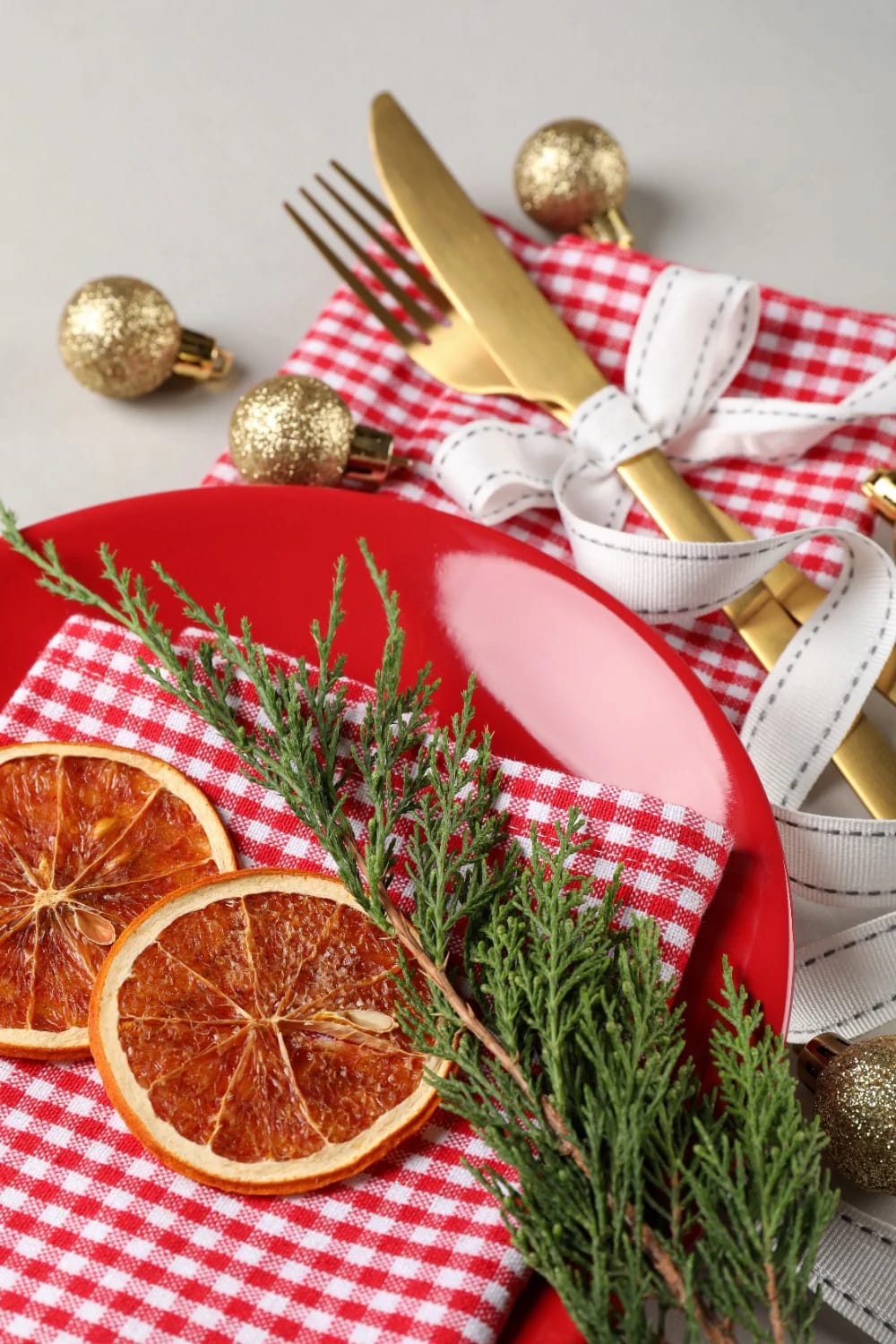 Natural Christmas Place Settings With Foraged Sprigs: 9 Ways to Set the Table 11 pair eucalyptus with a dried orange slice at every seat 1