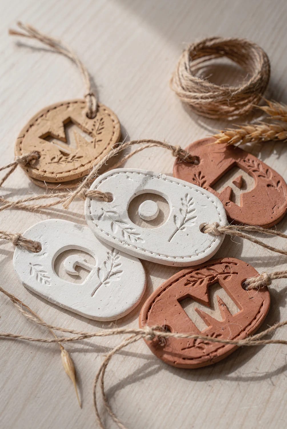 cut-out initial clay tags where the letter is the hole 1