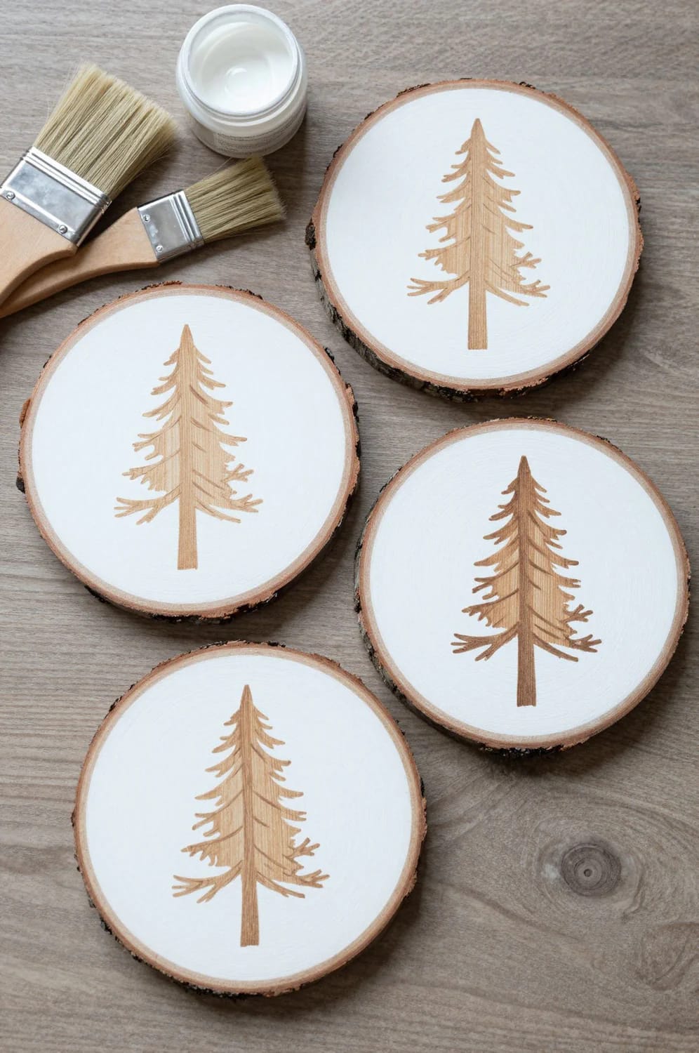 13 Painted Wood Slice Ornaments for a Minimalist Tree 9 negative-space pine: paint the sky, leave the tree bare 1
