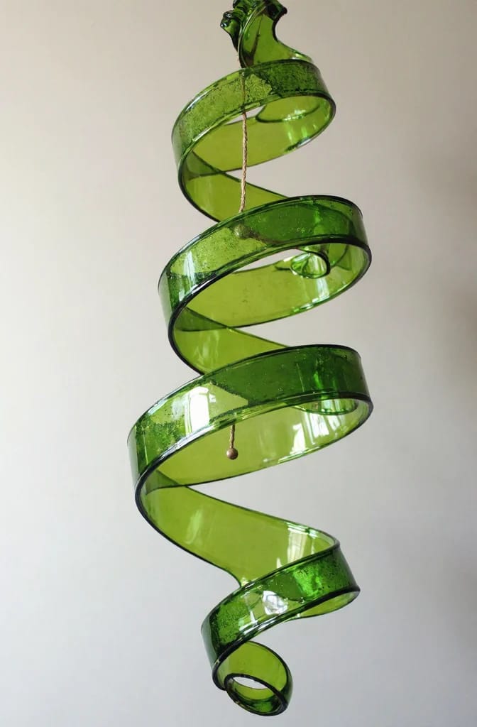 Plastic Bottle Flower Chandelier Shaping A translucent green plastic bottle is cut into a long spiral strip and suspended vertically, creating a curled chandelier-like decoration for shaping blooms.